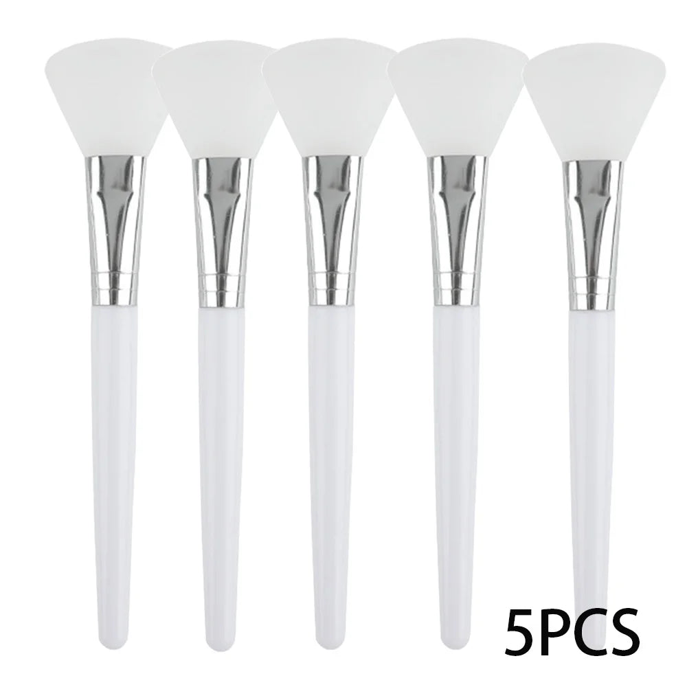 Five silicone face mask applicator brushes with white soft heads, silver ferrules, and white handles.