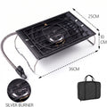 Portable camping stove with black grate, silver burner and hose, with storage bag