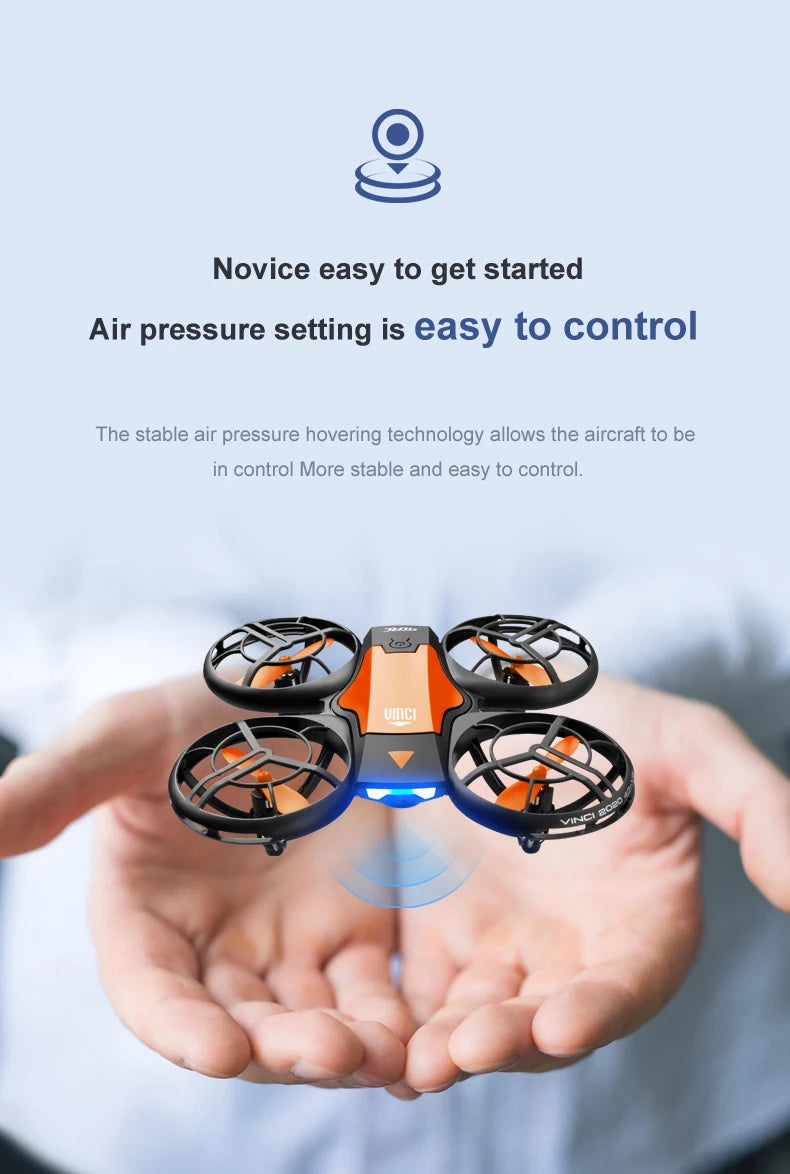 Small black and orange quadcopter drone with protective propeller guards, held in hands for easy flight stability.