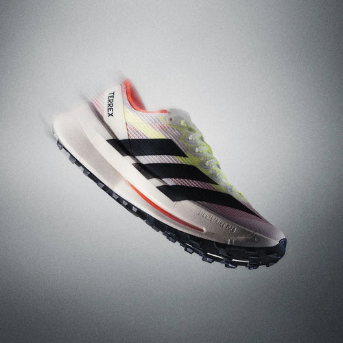 Adidas Terrex Agravic Speed 2 trail running sneakers: white mesh with black stripes, yellow accents, and thick foam.