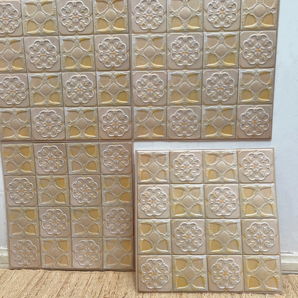 Peel-and-stick embossed backsplash tiles, gold textured square floral pattern