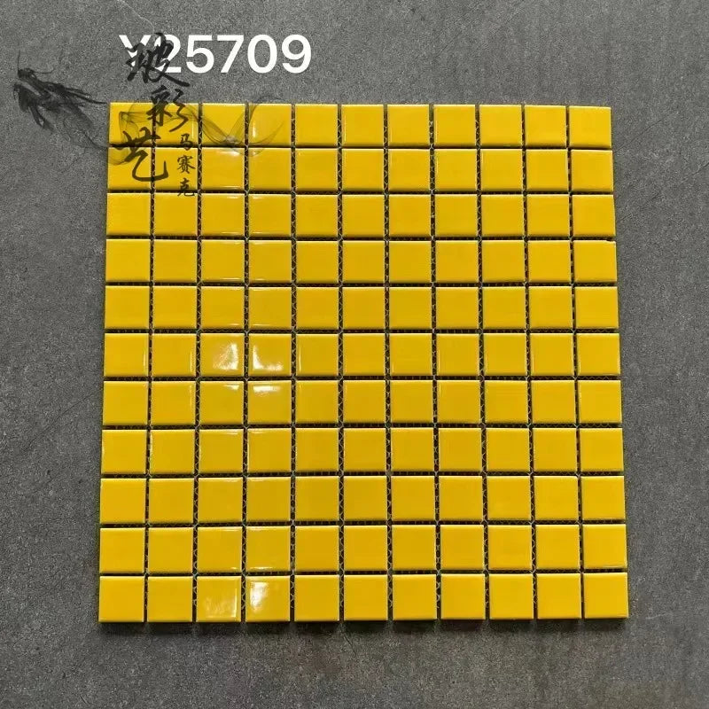 Bright yellow ceramic mosaic tile sheet with glossy square grid and dark grout lines
