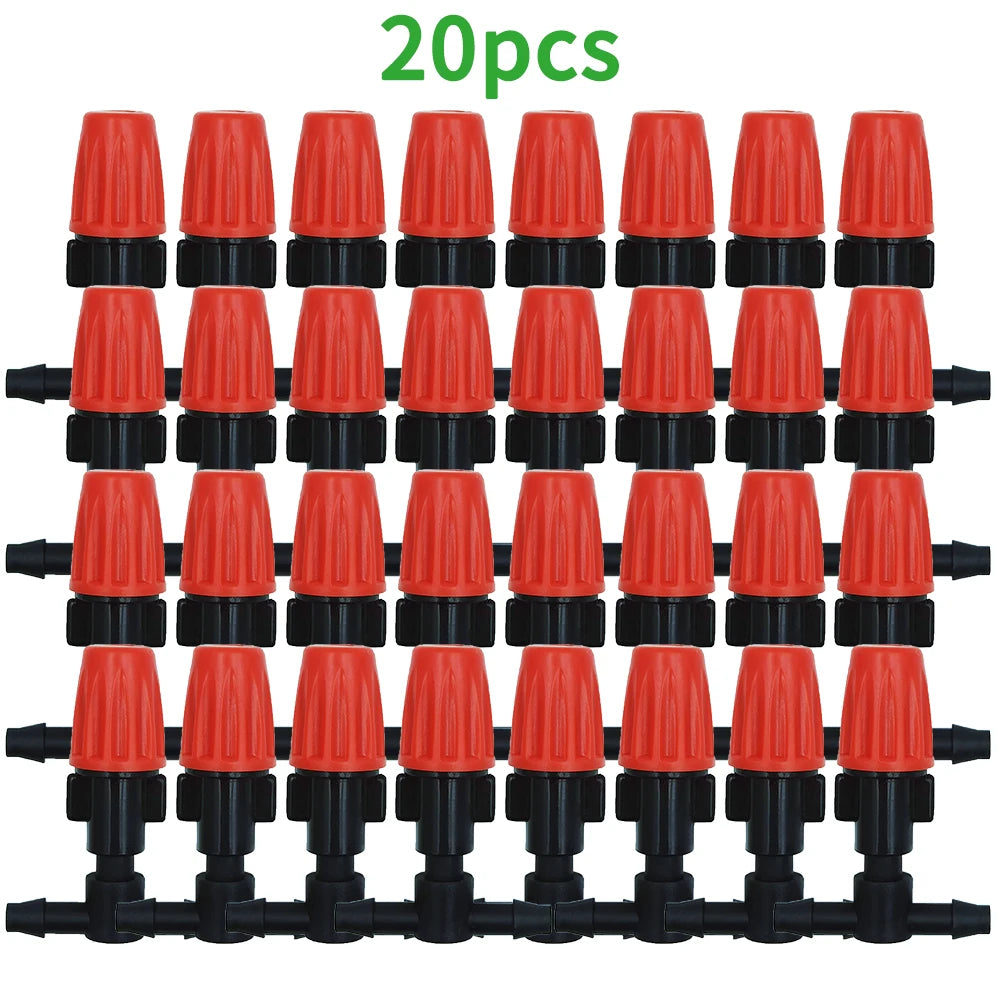 Orange dripper heads arranged on a black hose line for drip irrigation