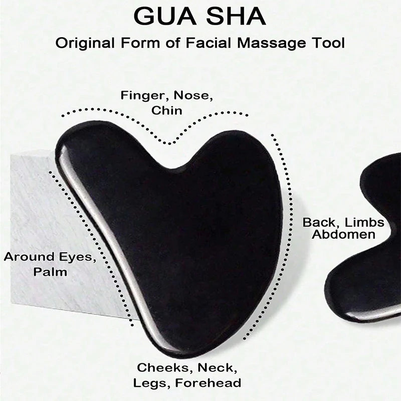 Two black heart-shaped Gua Sha facial massage tools with text labels indicating usage areas for body and face massage.