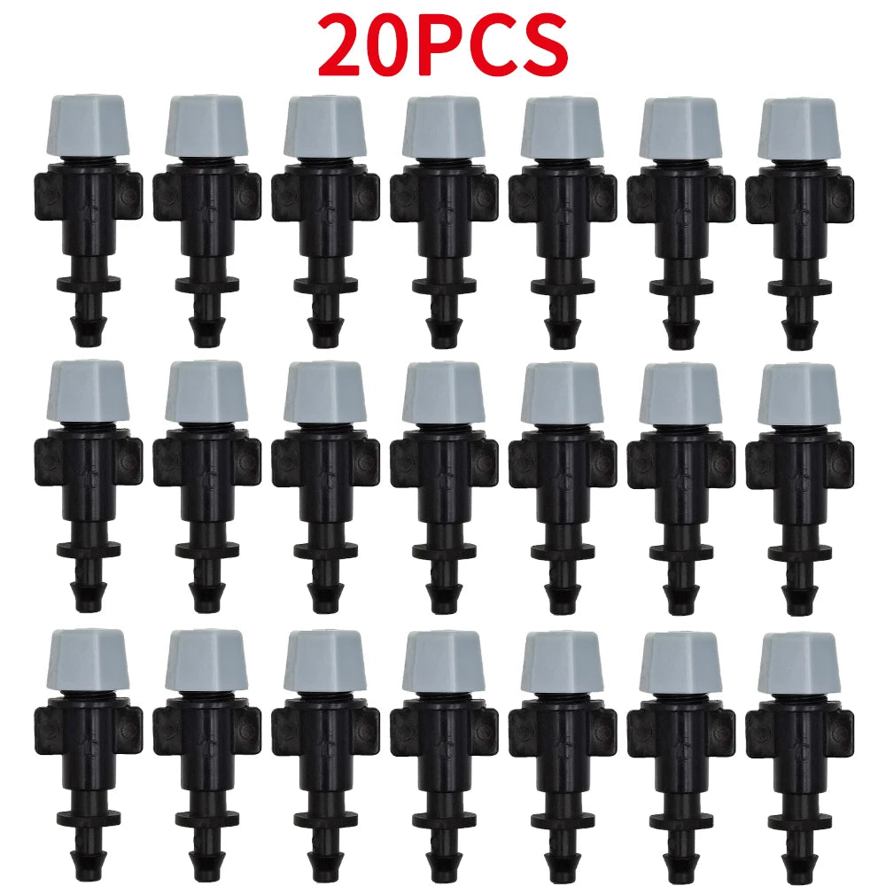 Cluster of drip irrigation emitters with black connectors and light caps, 20-pack