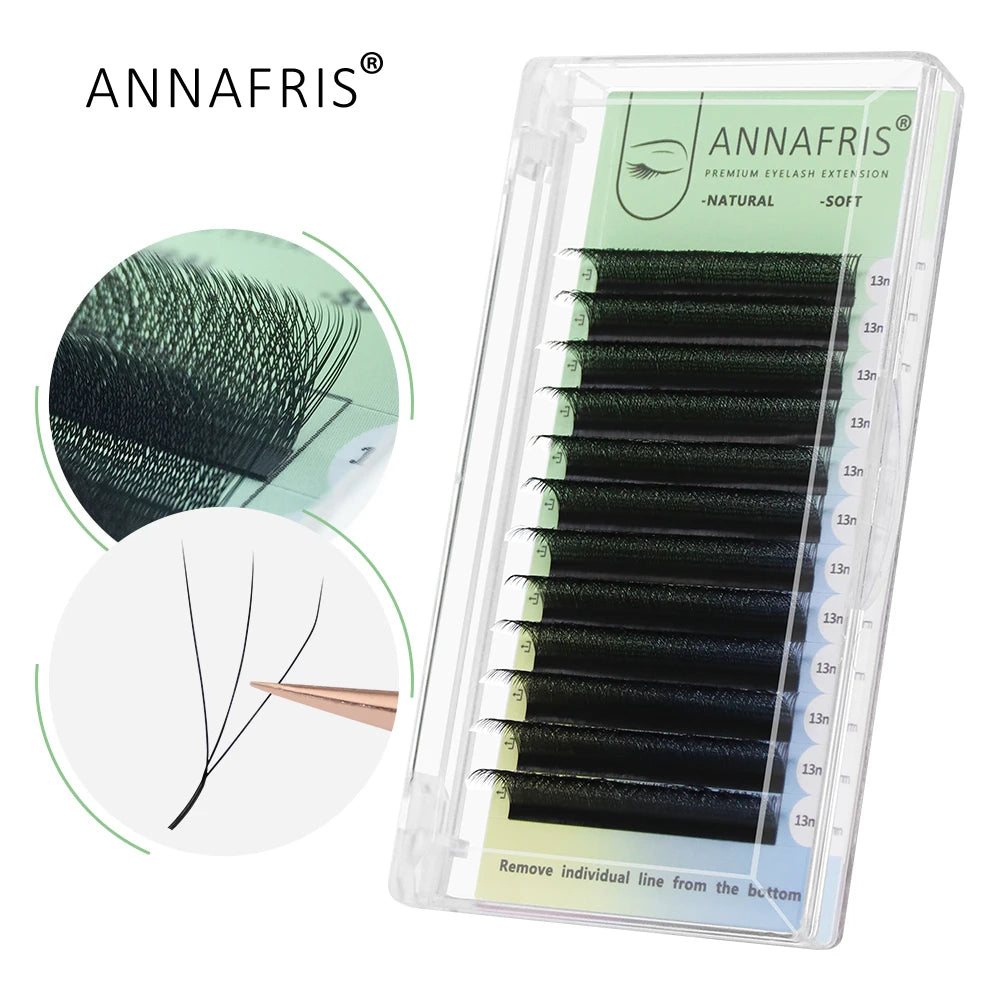 Black individual eyelash extension strips in a clear rectangular case, organized by length for professional application.