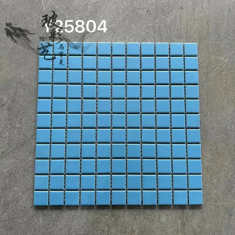 Ceramic mosaic tile sheet with bright blue squares and dark grout lines