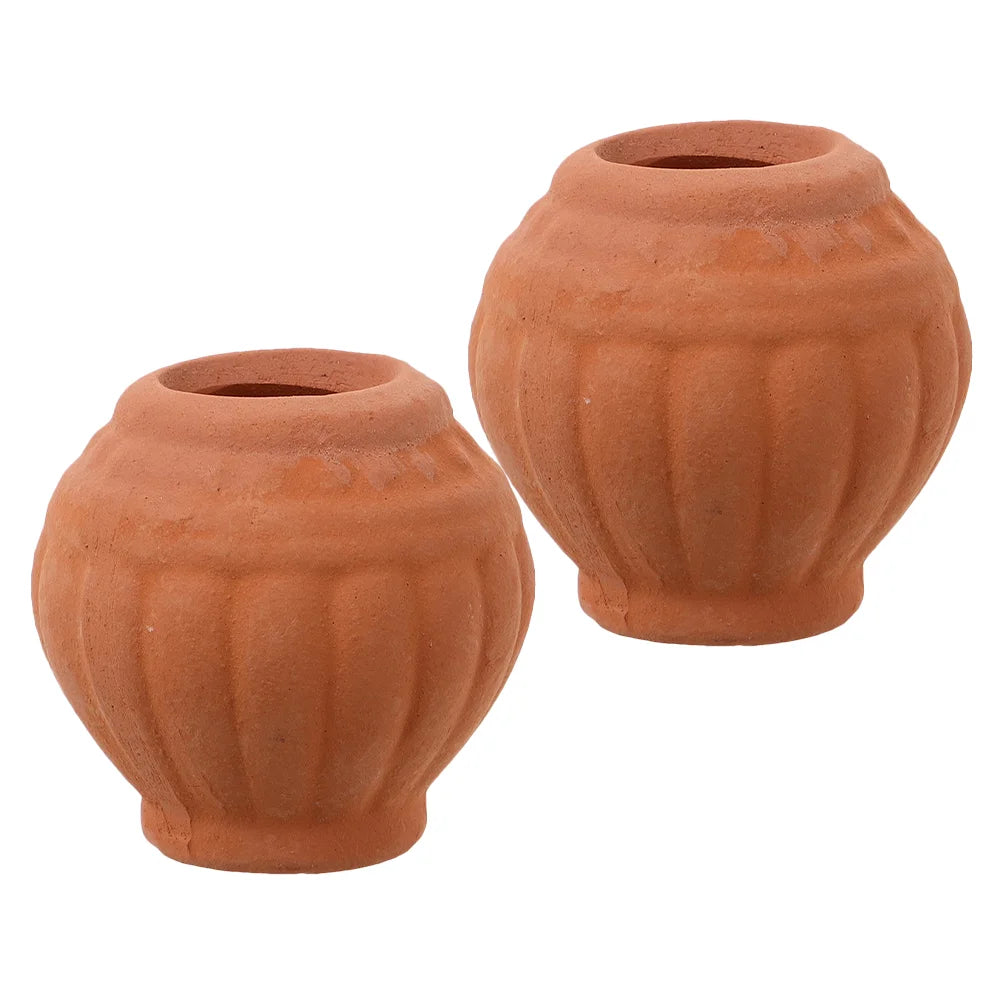 Two small terracotta clay succulent planter pots with textured ridges and drainage holes