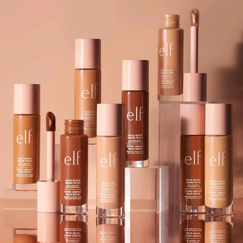 e.l.f. Halo Glow Liquid Filter foundation shades with applicator, displayed in glass bottles on a neutral background.