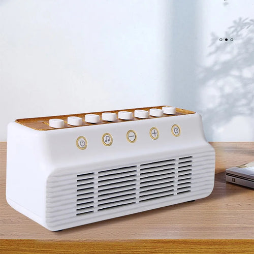 White noise machine for sleep in white with wood trim, featuring top tactile buttons and front control icons.