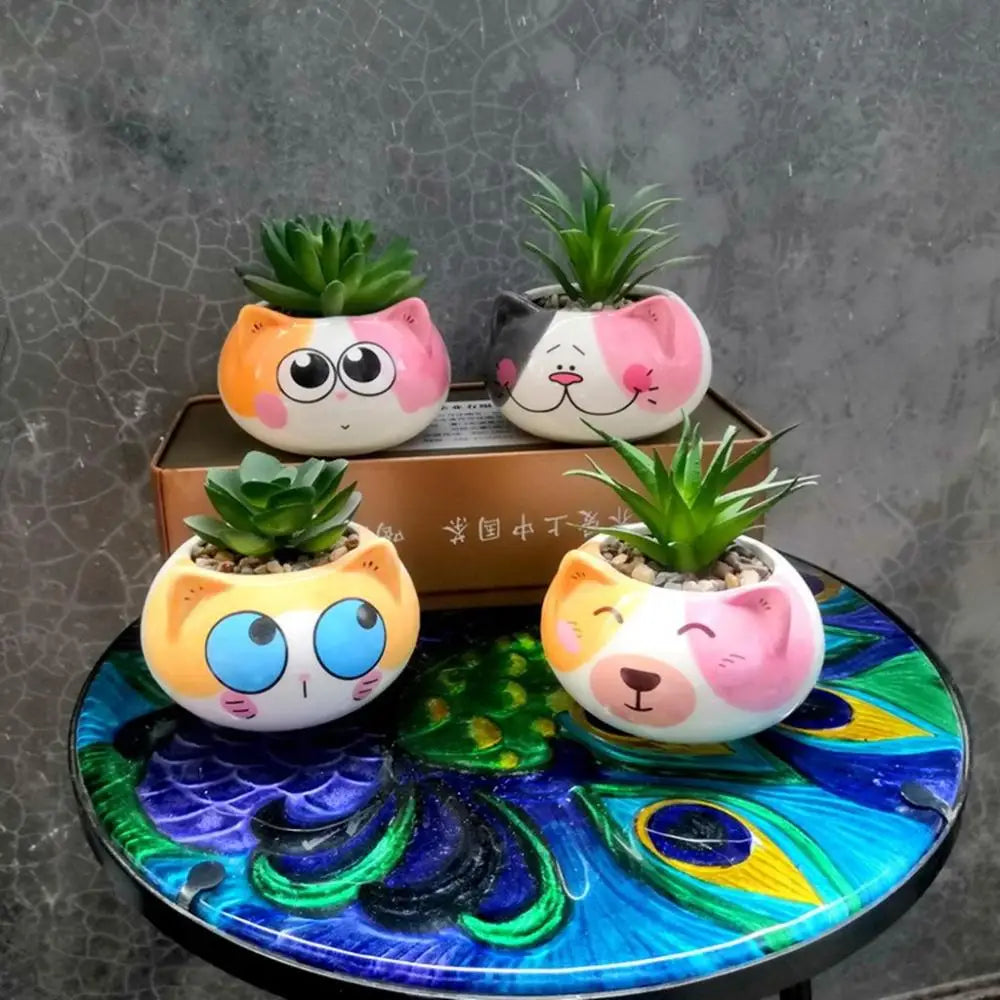 Assorted animal-face ceramic planters with small green succulents on a decorative round tray