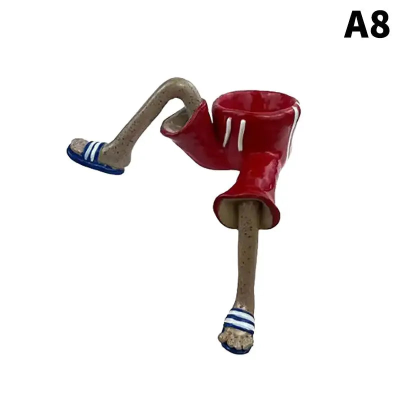 Red bowl leggy resin planter with gray legs and blue-striped shoe cuffs