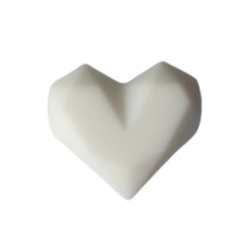 White heart-shaped silicone dust plug for Tamagotchi Uni, protects electronic pet charging ports from debris.
