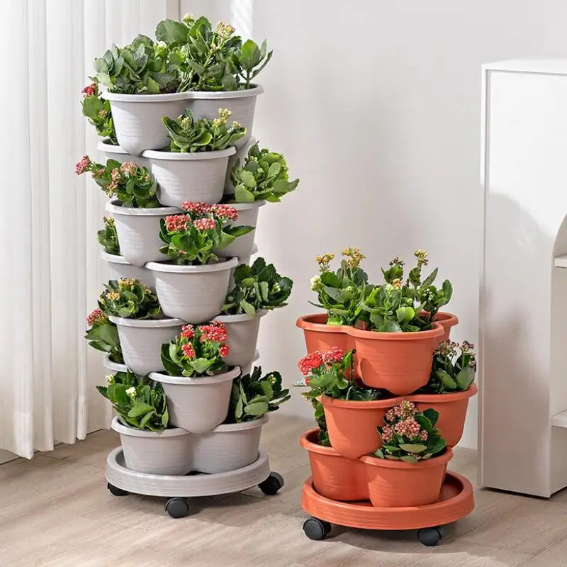 Vertical stackable planter tower with white and orange pots filled with plants