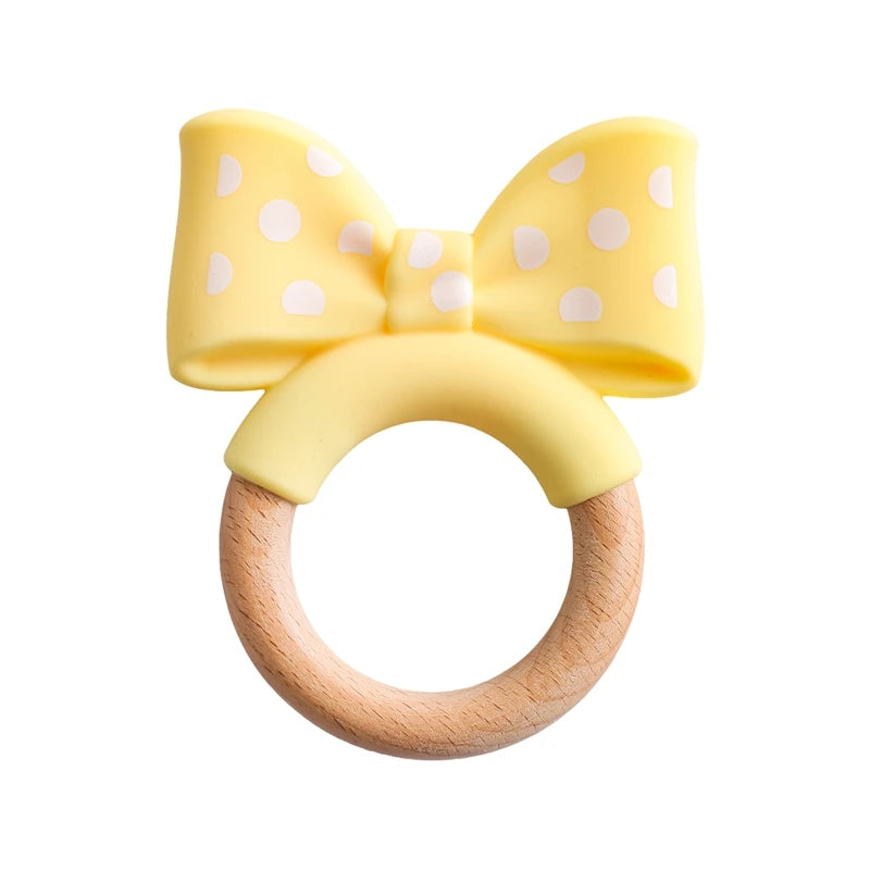 Yellow polka dot silicone and natural wood baby teething ring toy for infant relief.
