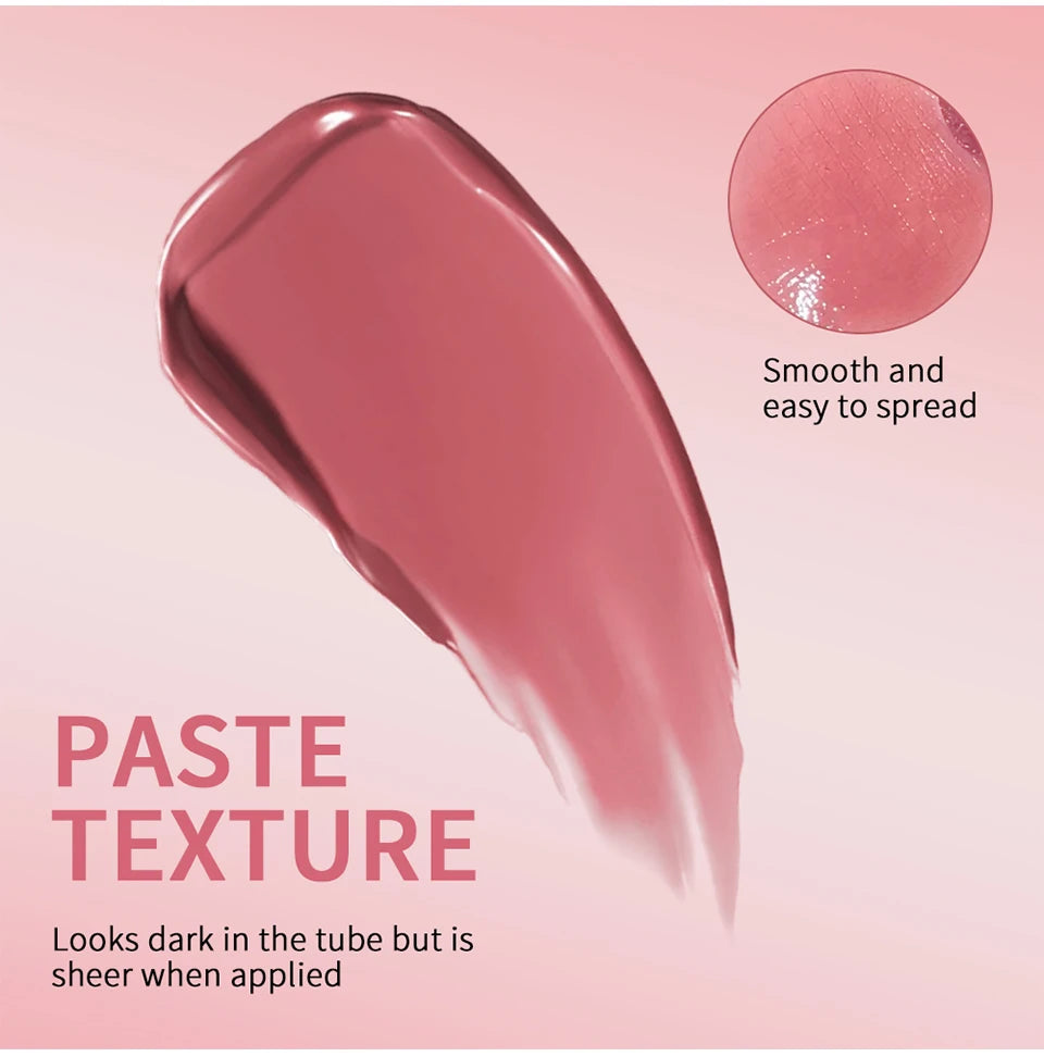 Swatch of smooth, nourishing brown-honey tinted lip balm showing a sheer, glossy, non-stick texture on a pink background.