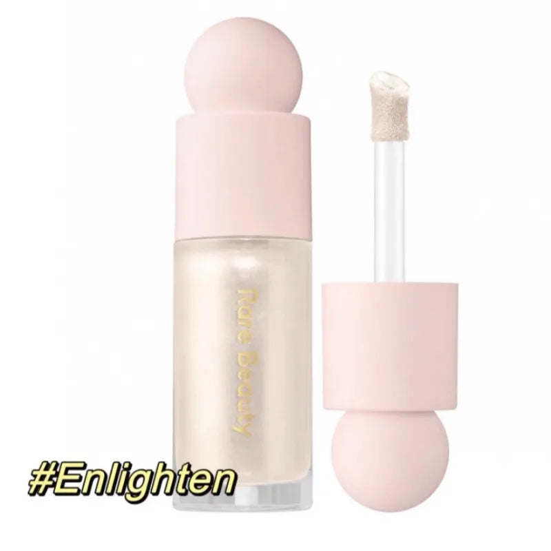 Rare Beauty Positive Light Liquid Luminizer in Enlighten: a champagne shimmer highlighter with doe-foot applicator.