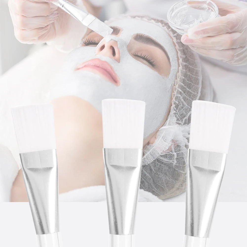 Three face mask brushes with soft white bristles, silver ferrules, and clear plastic handles.