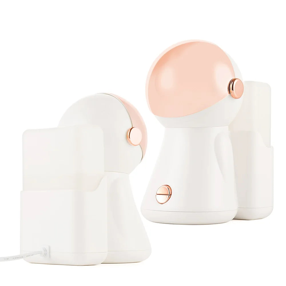 Astronaut-shaped white and rose gold humidifier with a charging dock base, used for desktop air moisturizing.
