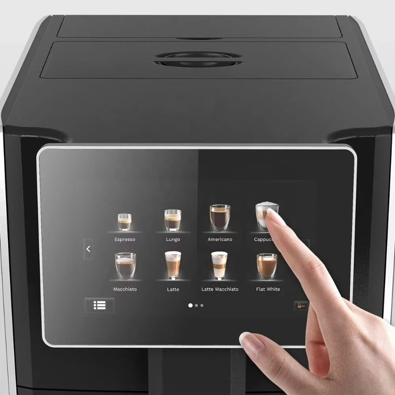 Finger touching digital touchscreen on a sleek black automatic coffee maker selecting a cappuccino drink.