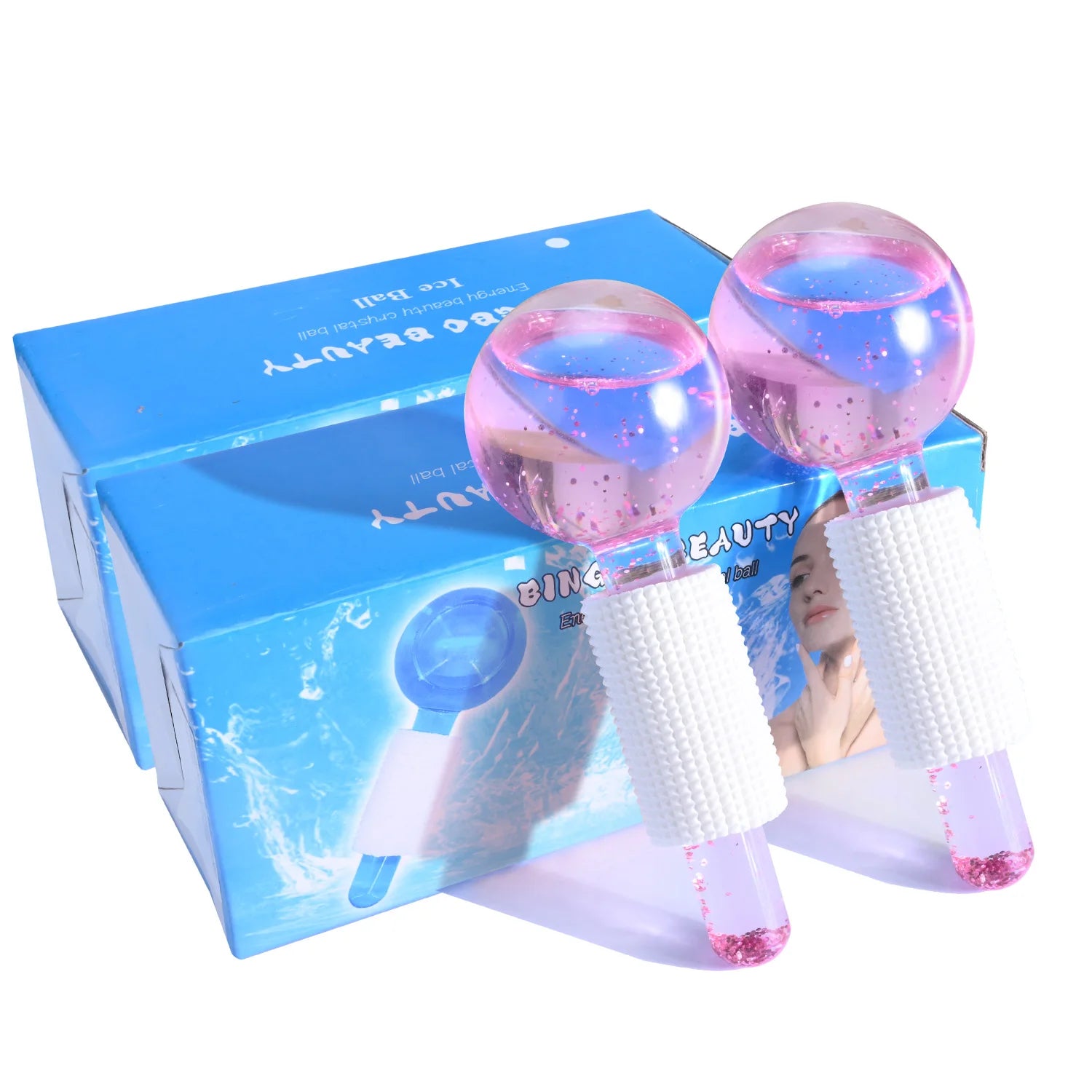 Two pink glitter-filled glass facial massage globes with white textured grips, shown with their blue packaging box.