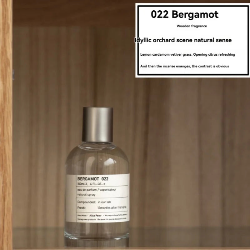 022 Bergamot unisex EDP, 100ml clear round bottle, fresh sandalwood, lemon, and vetiver fragrance notes.
