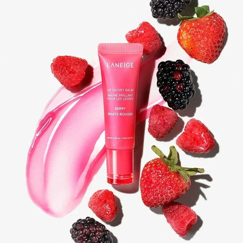 Laneige Berry Lip Glowy Balm tube with pink glossy balm texture and fresh strawberries, raspberries, and blackberries.