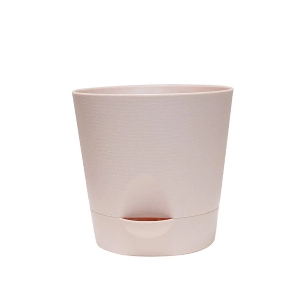 Light pink round plastic self-watering flower pot with removable bottom base