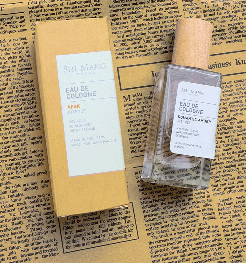 Shi Mang Romantic Amber EDP: Luxury woody amber women's fragrance in a rectangular glass bottle with wooden cap.