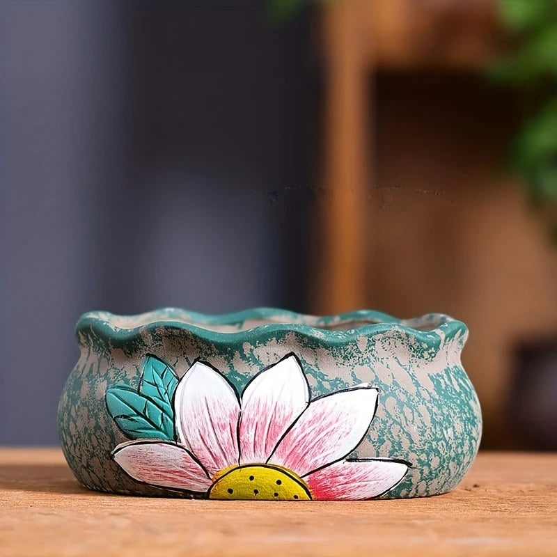 Ceramic oval flower planter with turquoise speckle finish and large pink flower