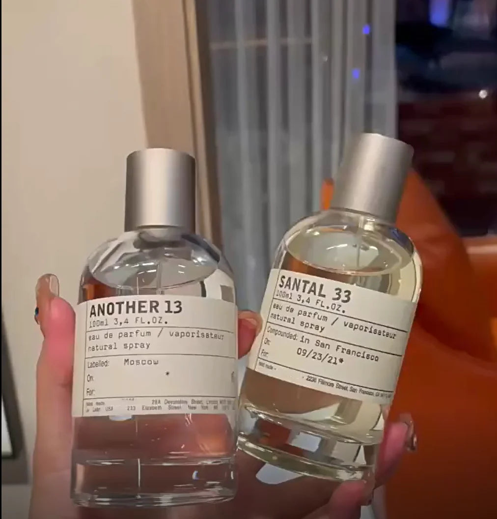 Le Labo Santal 33 & Another 13 unisex Eau de Parfum 100ml spray bottles in clear glass with apothecary-style labels.