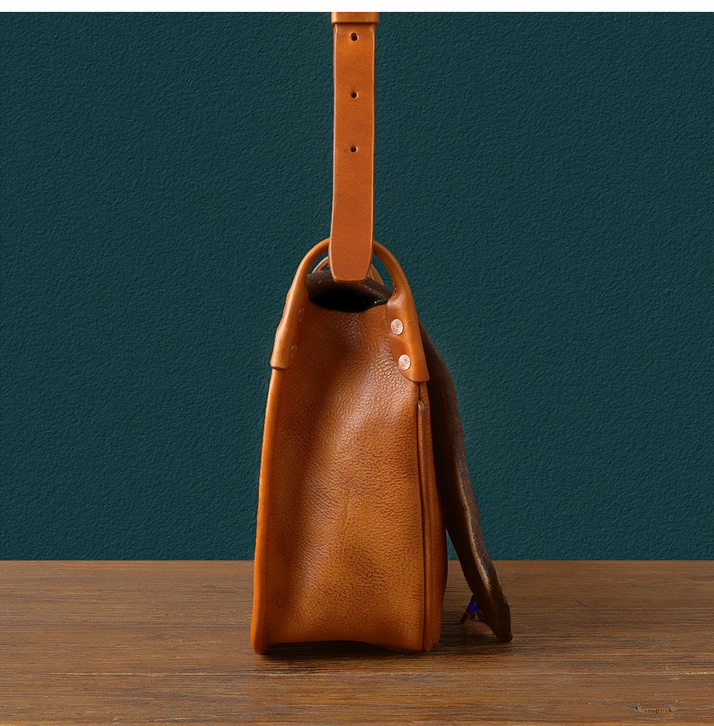 PNDME handmade vintage tan genuine cowhide leather messenger bag with adjustable shoulder strap and rivet detailing.