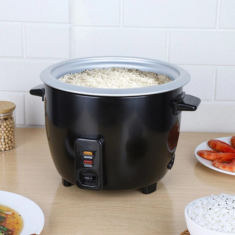 Mini electric rice cooker with black pot and glass lid, rice steaming inside