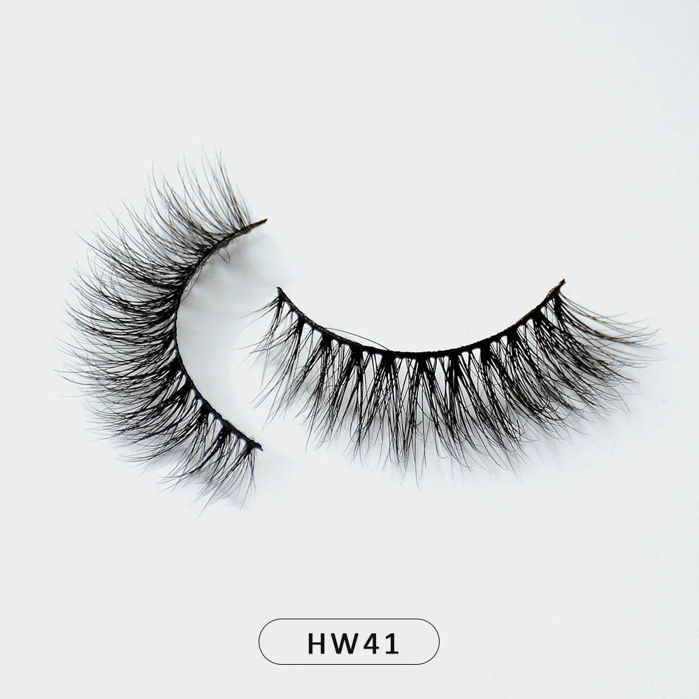 A pair of wispy, black 3D mink false eyelashes with a flexible band on a white background, labeled HW41.