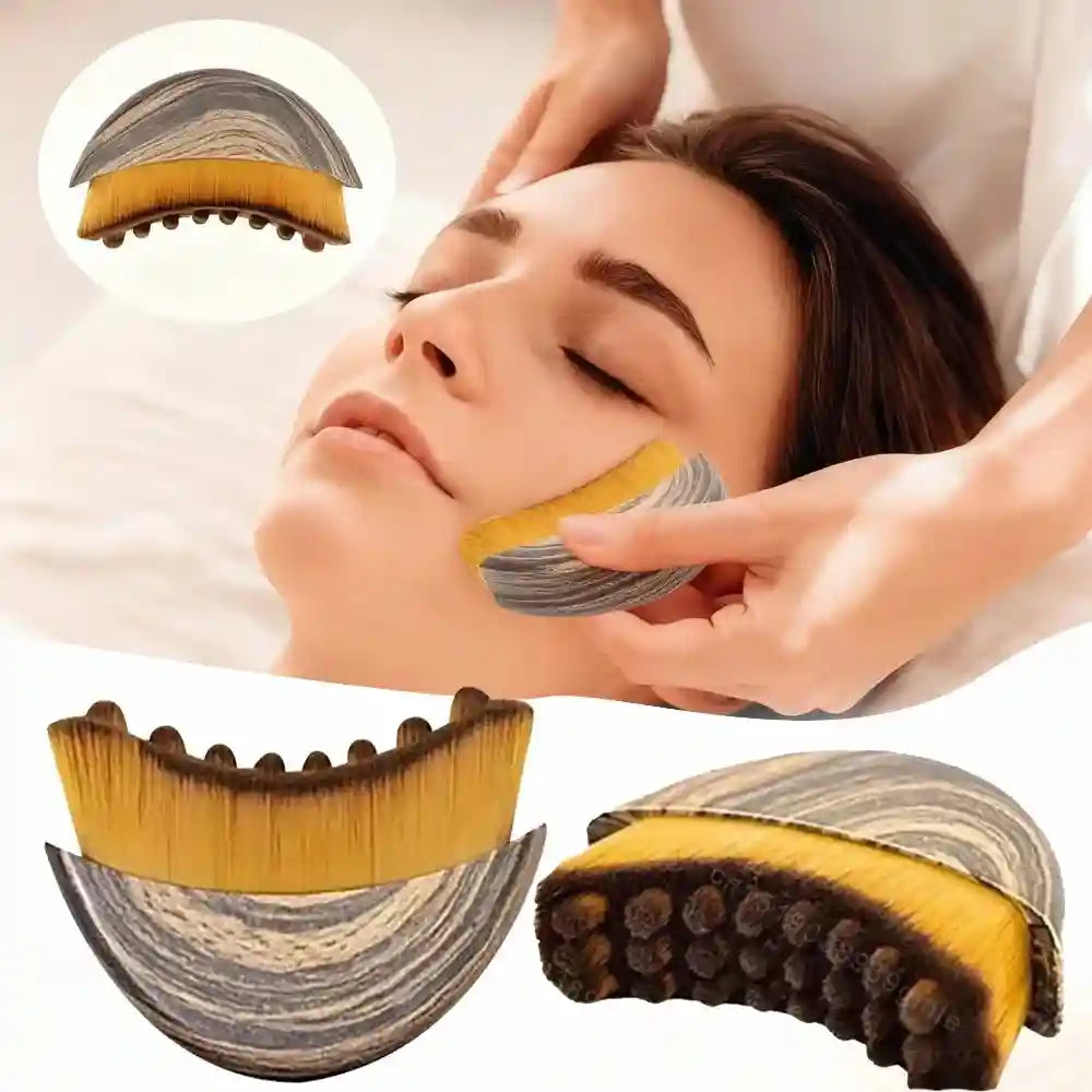 Crescent-shaped facial massage brush with wood-grain handle and soft yellow bristles, used for lymphatic contouring.
