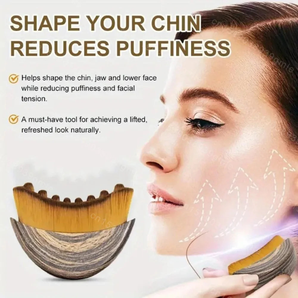 Curved facial massage brush with brown-black faux wood handle and soft bristles, shown alongside a model’s jawline.