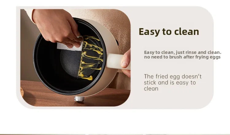 Electric hot pot with dark nonstick inner pot and hands removing food residue