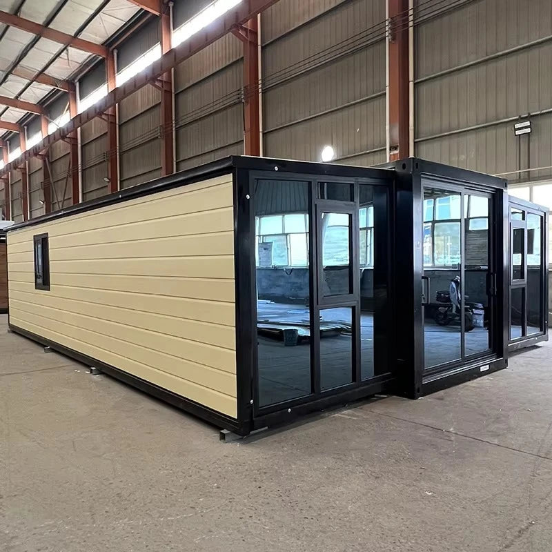 Cream and dark modular container house with black-framed glass doors and windows