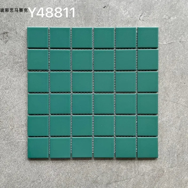 Ceramic mosaic tile sheet with teal green squares and dark grout lines