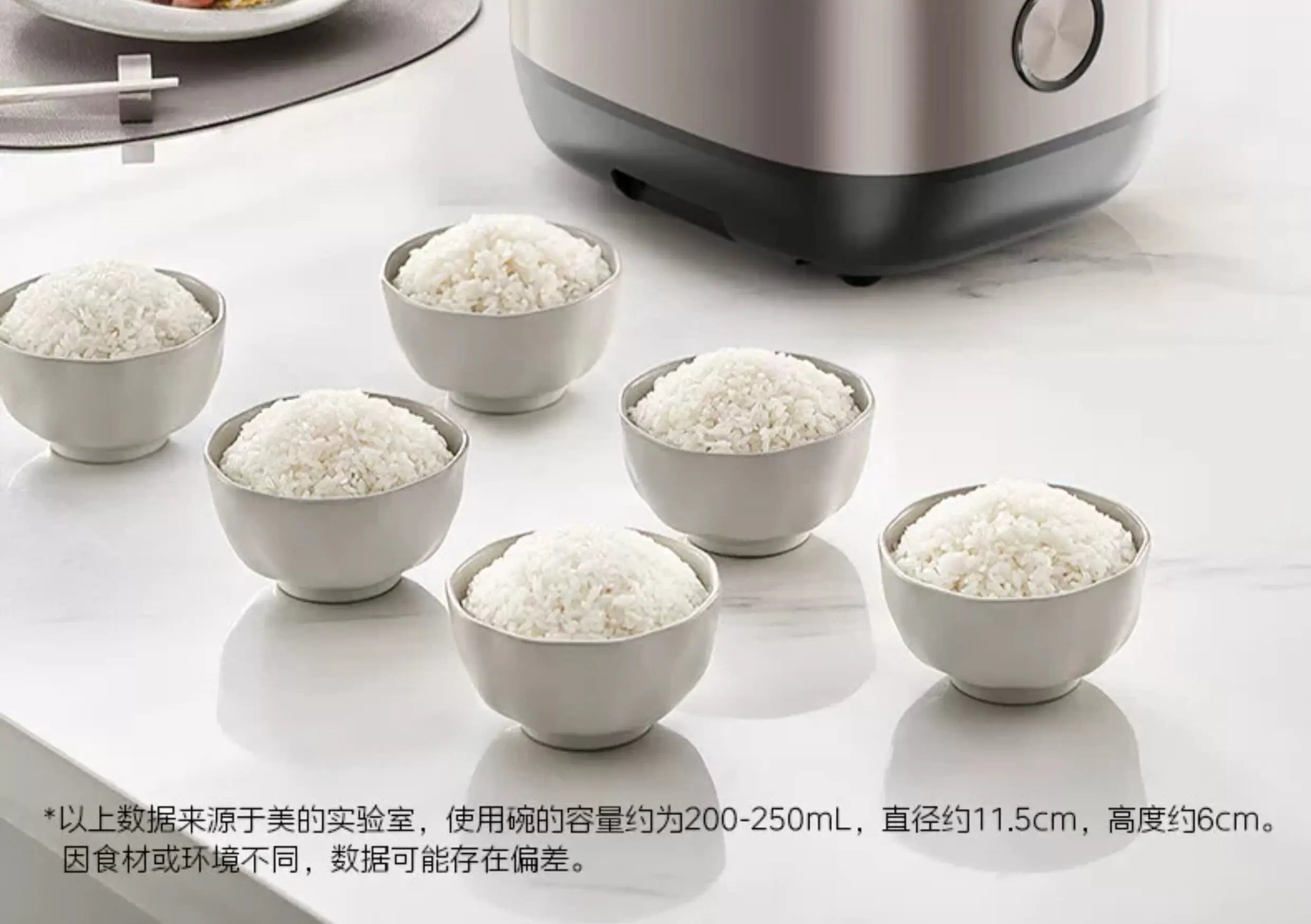Rice cooker serving rice in multiple white bowls