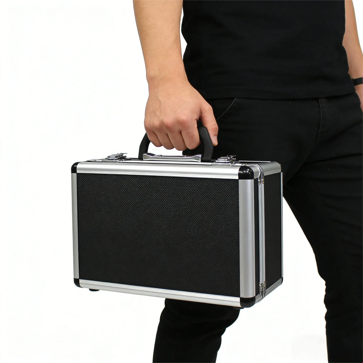 Handheld inkjet printer held beside a black metal suitcase with chrome edges
