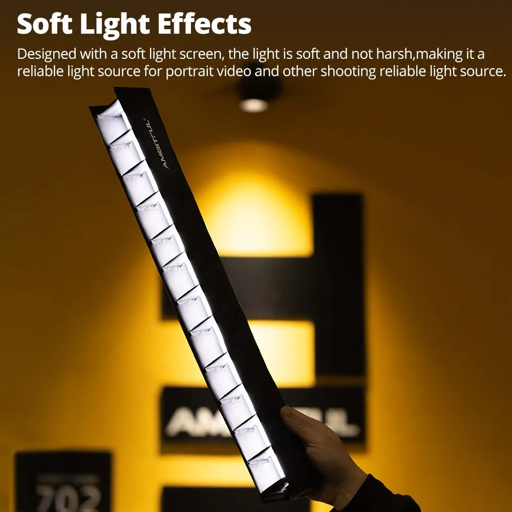 Long, rectangular black LED light bar with a soft diffusion panel, held by hand for portrait and video photography.