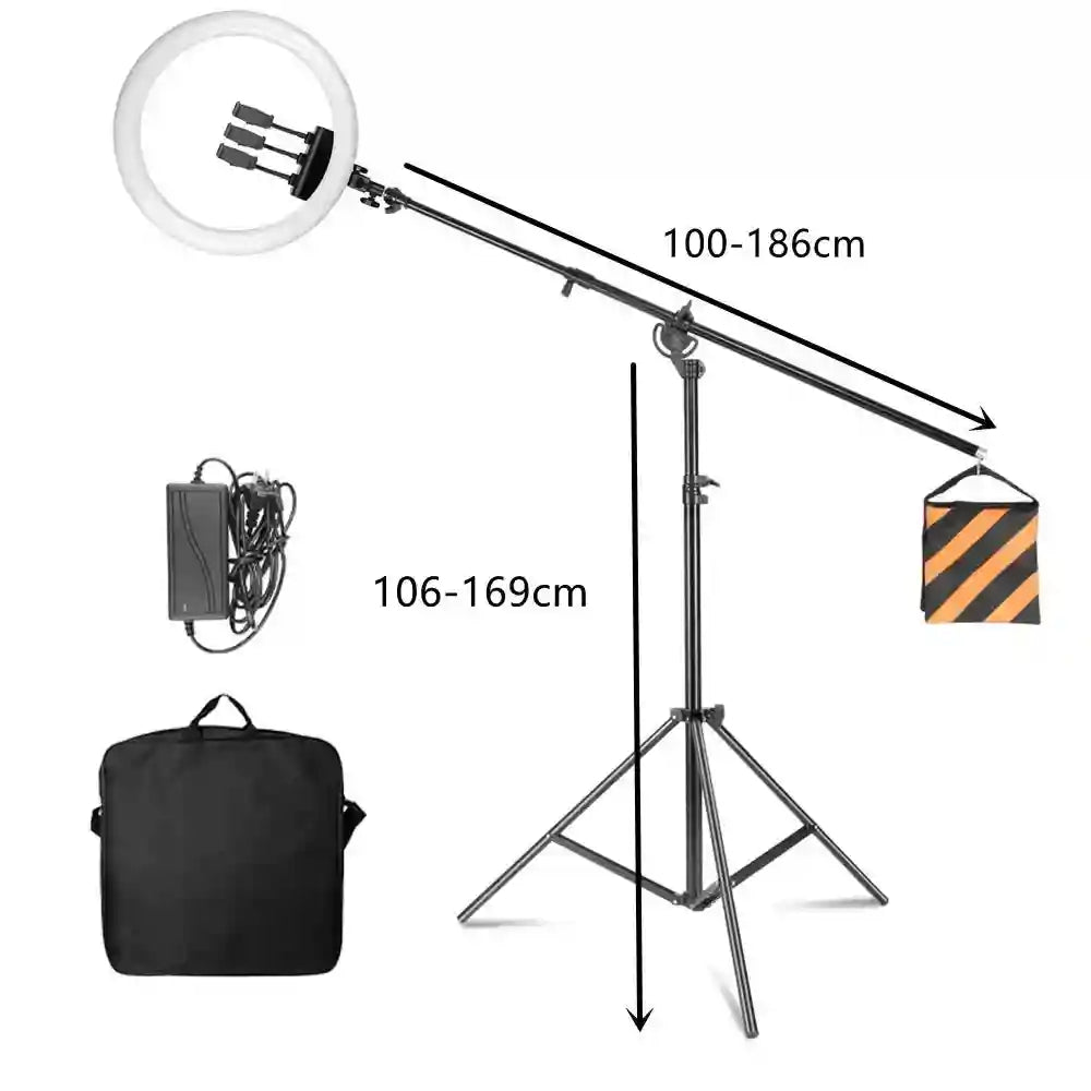 Circular LED ring light on an adjustable boom arm stand with tripod base, power supply, counterweight, and carry bag.