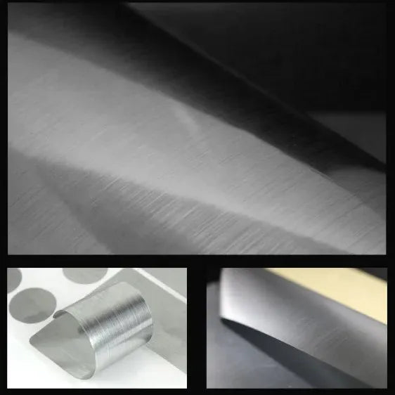 Silver printable vinyl film close-up on paper sheet and roll, matte texture.