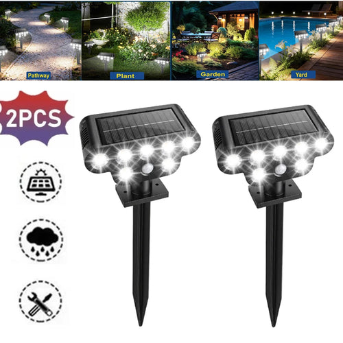 Two black solar-powered LED pathway lights with integrated solar panels and ground stakes for outdoor landscaping.