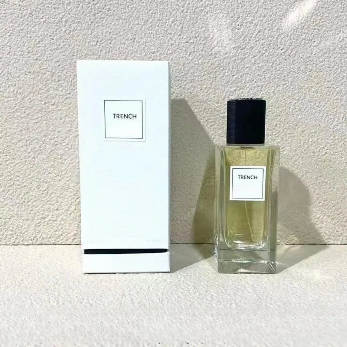 Trench unisex 125ml perfume: oriental woody grapefruit floral scent in a sleek rectangular glass bottle with black cap.