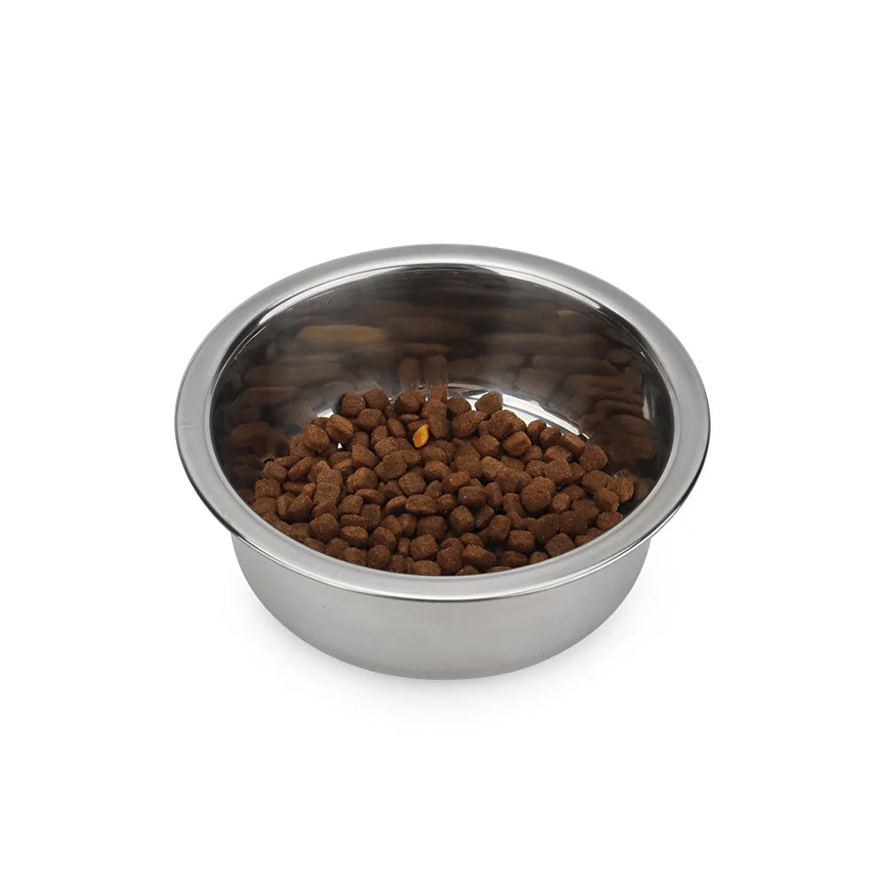Durable round stainless steel bowl filled with dry food for small to medium dogs and cats. Easy-clean pet feeder.