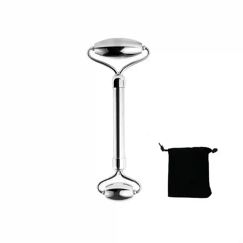Dual-ended silver stainless steel facial roller tool with a black velvet storage pouch against a white background.
