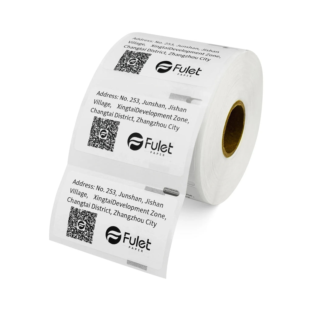 White barcode label roll with printed address blocks and QR codes.