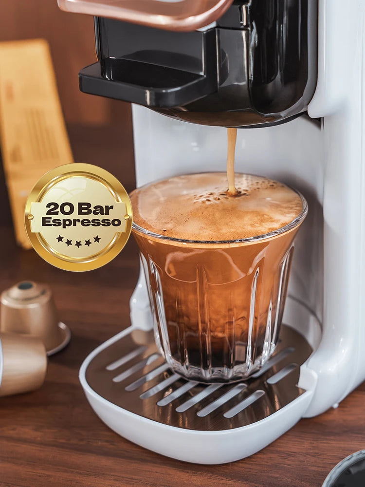 White 20 bar espresso capsule coffee maker brewing into a glass cup with gold accents.
